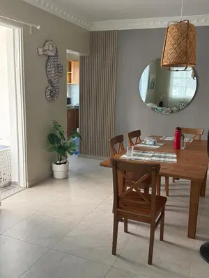 a dining room with a table and a mirror at Lunamare Residence in Los Grini