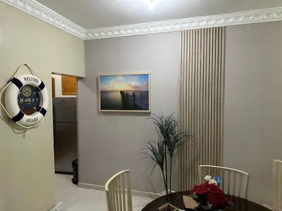 a dining room with a table and a clock on the wall at Lunamare Residence in Los Grini
