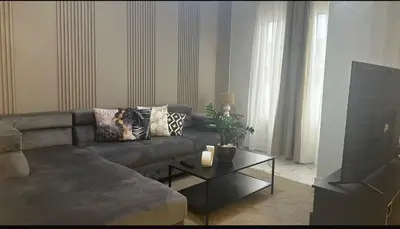 a living room with a couch and a table at Los laureles in Puerto Plata
