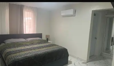 a bedroom with a bed in a room with a window at Los laureles in Puerto Plata