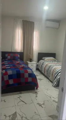 a bedroom with two beds and a tiled floor at Los laureles in Puerto Plata