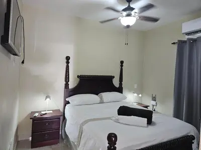 a bedroom with a bed and a ceiling fan at Sweet Home in Monte Llano