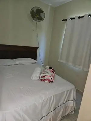 a bedroom with a white bed with a fan at Sweet Home in Monte Llano