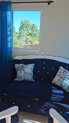 a blue couch in a living room with a window at Sweet Home in Monte Llano