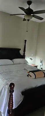 a bedroom with a bed with a ceiling fan at Sweet Home in Monte Llano