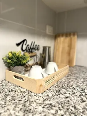 a wooden tray with cups on a counter top at Belive 01 Condo in Santiago, the heart of the city in Santiago de los Caballeros