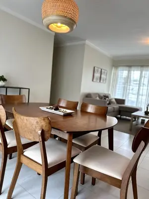 a dining room with a wooden table and chairs at Belive 01 Condo in Santiago, the heart of the city in Santiago de los Caballeros