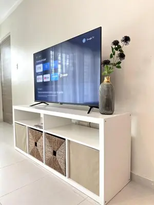 a television on a white tv stand in a living room at Belive 01 Condo in Santiago, the heart of the city in Santiago de los Caballeros