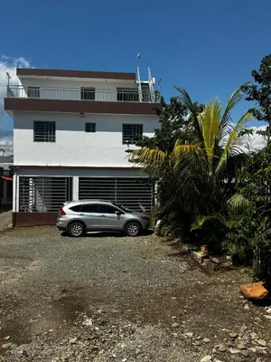 a car parked in front of a house at Hermoso Apartamento en 3er nivel con terraza privada in Bonao