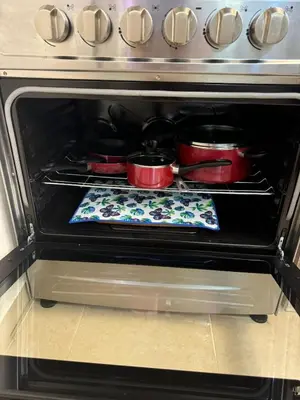 an oven with pots and pans on a towel in it at Sweet dreams Tropical paradise in San Isidro
