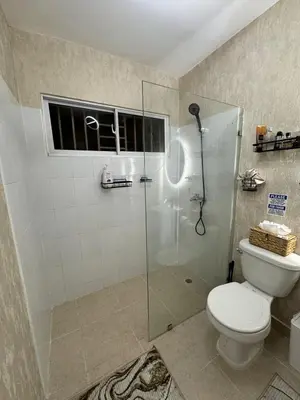 a bathroom with a toilet and a glass shower at Sweet dreams Tropical paradise in San Isidro