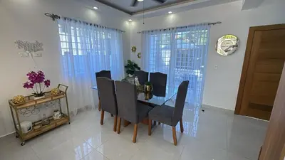 a dining room with a table and chairs at Villa Tropical Paradise Pool Rooftop in San Felipe de Puerto Plata