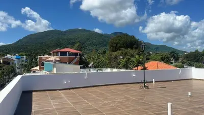 a view from the roof of a house with mountains in the background at Villa Tropical Paradise Pool Rooftop in San Felipe de Puerto Plata