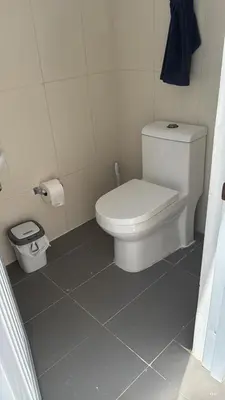 a bathroom with a white toilet and a trash can at Villa Tropical Paradise Pool Rooftop in San Felipe de Puerto Plata