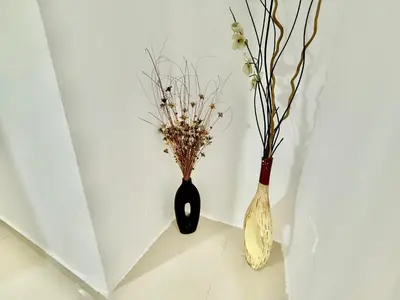 two vases with flowers in them sitting next to a wall at corales apartamento lll in La Viva