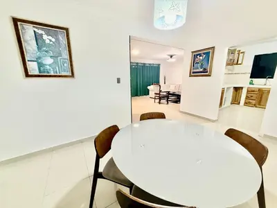 a white dining room with a white table and chairs at corales apartamento lll in La Viva