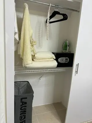 a walk in closet with towels on a shelf at Sweet dreams Tropical paradise in San Isidro