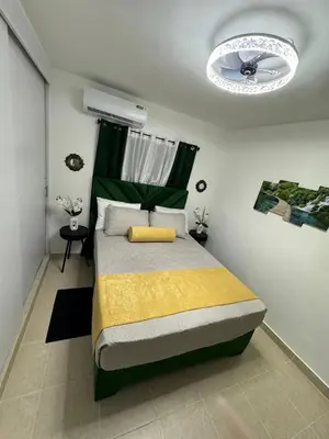 a bedroom with a bed and a ceiling fan at Sweet dreams Tropical paradise in San Isidro