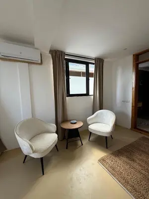 a room with two chairs and a table and a window at Kainos Tropical Boutique Hotel in Las Terrenas