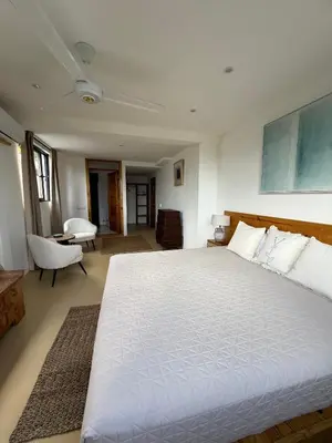 a bedroom with a large white bed in a room at Kainos Tropical Boutique Hotel in Las Terrenas