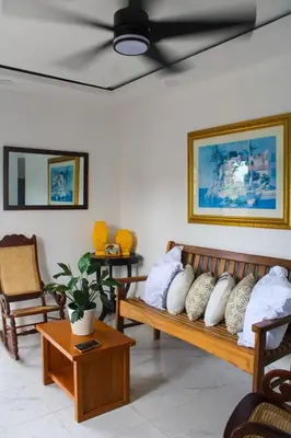 a room with two wooden benches with pillows on them at Acogedor apartamento a cerca de la playa in San Felipe de Puerto Plata