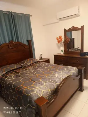 a bedroom with a bed with a dresser and a mirror at Cerca de la playa apartamento familiar in Punta Cana