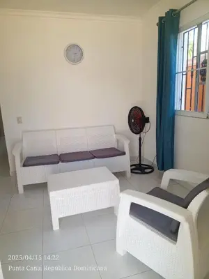 a living room with a couch and a table at Cerca de la playa apartamento familiar in Punta Cana