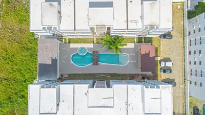 an overhead view of a building with a swimming pool at Cozy 2BR Apartment in Sunshine Bayahibe in San Rafael del Yuma