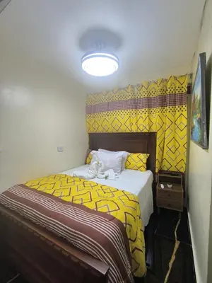 a bedroom with a bed with a yellow blanket at Escape en terrazas del caribe con psicina y playa in Boca Chica