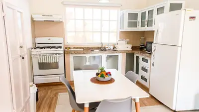 a kitchen with a table and a white refrigerator at Apartamento de 2 habitaciones in Colorado