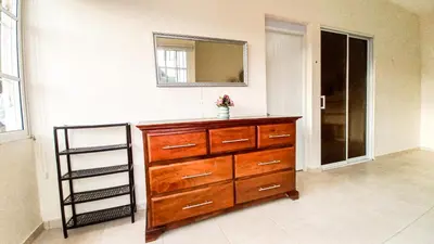 a bathroom with a dresser and a mirror on a wall at Apartamento de 2 habitaciones in Colorado