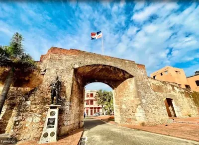 an old stone bridge with a flag flying over it at Casa Estrellita-Romantic getaway in Santo Domingo