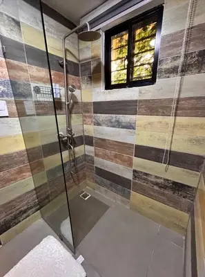 a bathroom with a shower with a glass door at Casa Estrellita-Romantic getaway in Santo Domingo