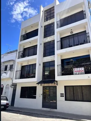 a white building with a sign on it at Casa Estrellita-Romantic getaway in Santo Domingo