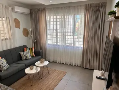 a living room with a couch and two tables at Casa Estrellita-Romantic getaway in Santo Domingo