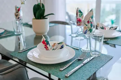 a glass table with a plate and a bowl on it at Cozy City Center 2BD Condo, in Santo Domingo