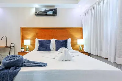 a bedroom with a bed with a stuffed animal on it at Cozy City Center 2BD Condo, in Santo Domingo