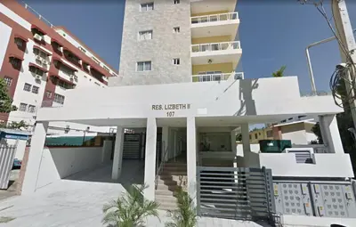 a white building with a sign that reads east west city at Cozy City Center 2BD Condo, in Santo Domingo