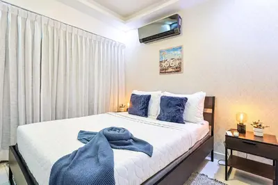 a bedroom with a bed with a blue towel on it at Cozy City Center 2BD Condo, in Santo Domingo