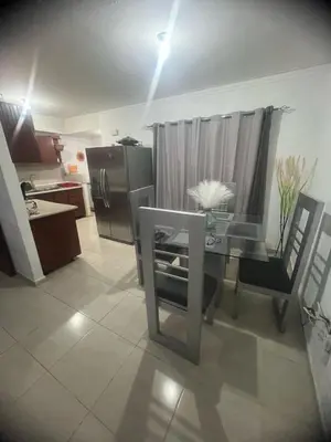 a kitchen with a glass table and a refrigerator at Beautiful accommodation in Los Paredones