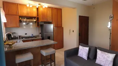 a kitchen and living room with a couch and a counter at Juan Dolio Near Beach, Pool Cozy Stay in Villas del Mar