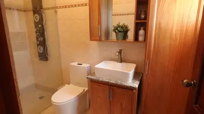 a small bathroom with a toilet and a sink at Juan Dolio Near Beach, Pool Cozy Stay in Villas del Mar