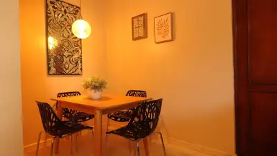 a dining room with a wooden table and chairs at Juan Dolio Near Beach, Pool Cozy Stay in Villas del Mar