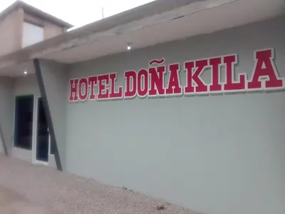 a hotel doza kitt sign on the side of a building at Hotel Doña kila in El Catey