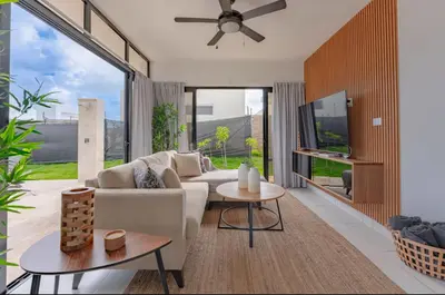 a living room with a white couch and a large window at My luxury villa in Sosúa