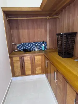 a kitchen with wooden cabinets and a counter top at Villa Tropical Paradise Pool Rooftop in San Felipe de Puerto Plata
