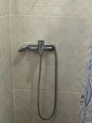 a shower with a hose in a bathroom at Buenos Aires Apartments in Río San Juan