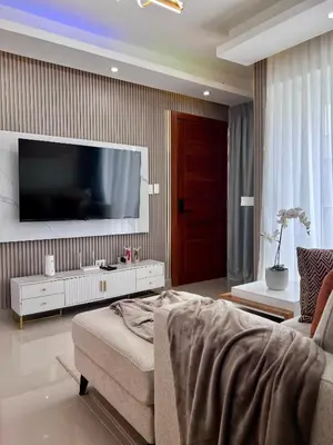 a living room with a large tv on a wall at Sky Golden in Los Altos de Jalisco