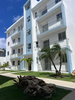 a white building with palm trees in front of it at Sky Golden in Los Altos de Jalisco