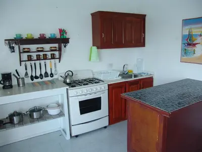a kitchen with a stove and a white stove top oven at Surf & Stay Waveriders, Encuentro in Cabarete